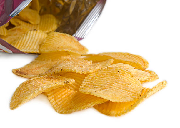 oval crinkled potato chips with pack (isolated, clipping path) stock photo