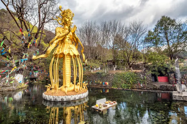 beautiful view of god of nature and waterfall stream outdoor flowing in jade village , lijiang , yunnan , China