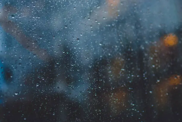 Photo of Closeup of raindrops on window glass.