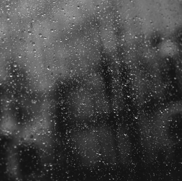 istock Square closeup of raindrops on window glass. 927447110