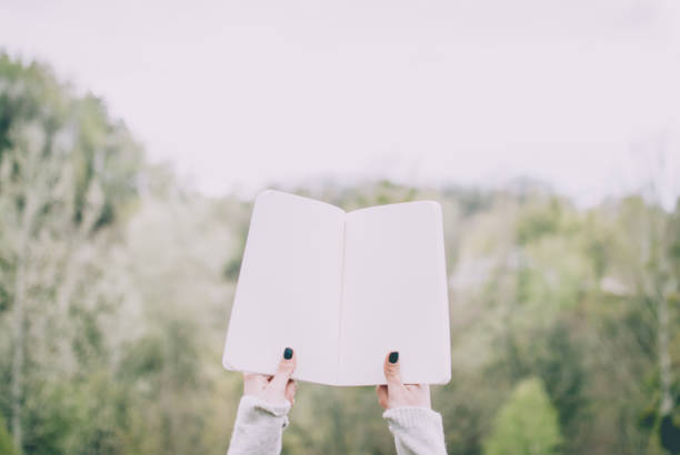 istock Girl holding a notebook. Blank paper of notebook. 927447142