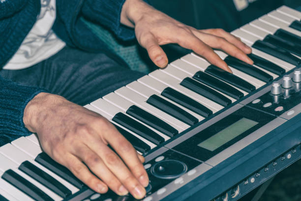 Hands of a pianist. Plays on the synthesizer