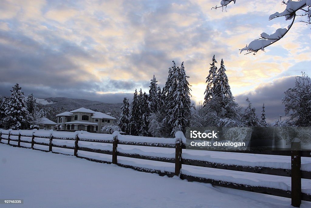 Snowy Winter Sunset Snowy winter sunset with fence and home Agricultural Field Stock Photo