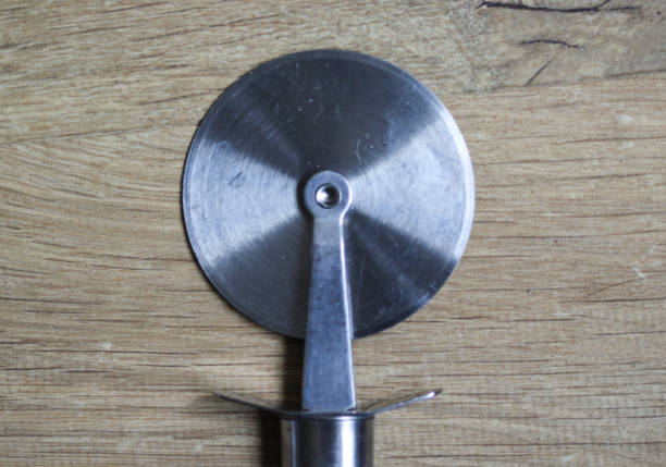istock pizza slicer on wooden background in kitchen 927456268