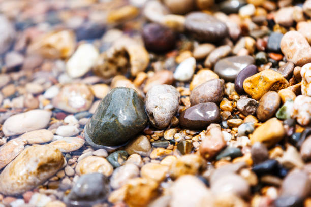 istock A close up view of smooth polished multicolored stones on the beach 927456428