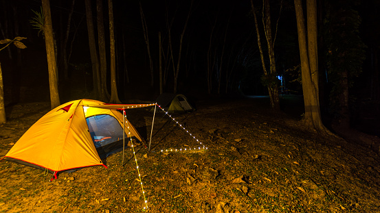 Orange tent glows under night