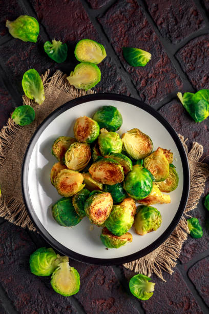 istock Homemade Roasted Brussel Sprouts with Salt, Pepper on a old stone rustic table 927468154