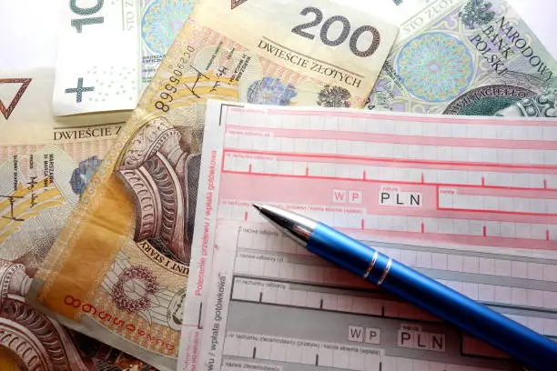 Photo of Polish cash payment form, banknotes and pen