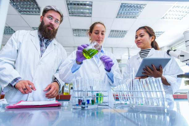 istock Young scientists working in a chemical lab 927477380