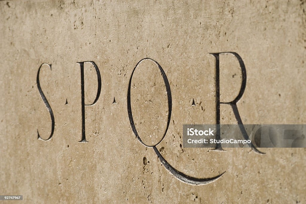 Rome SPQR An old inscription of the letters SPQR. “Senatus Populusque Romanus”. Inscripted in the marble stone of a statue in Rome. Ancient Stock Photo