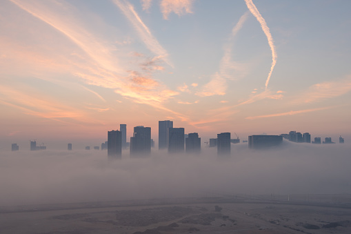Early morning view of a fog covered Al Reem island seen from Abu Dhabi island, capital city of the United Arab Emirates