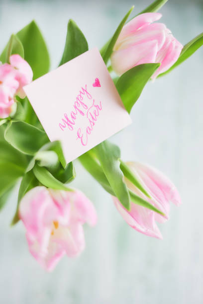 istock Pink tulips in vase on a wooden table 927481820