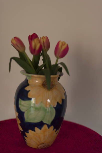 istock Red tulips in blue vase. 927481830