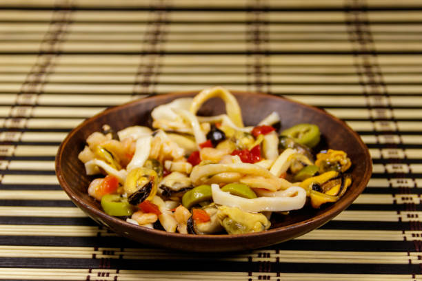 Seafood salad with shrimp, squid and mussels on bamboo mat