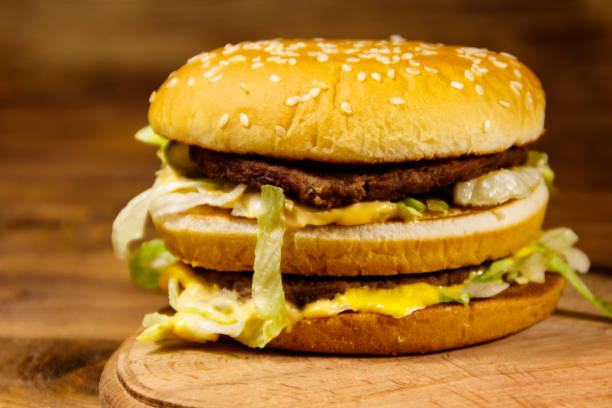 istock Delicious big hamburger on wooden table 927495904