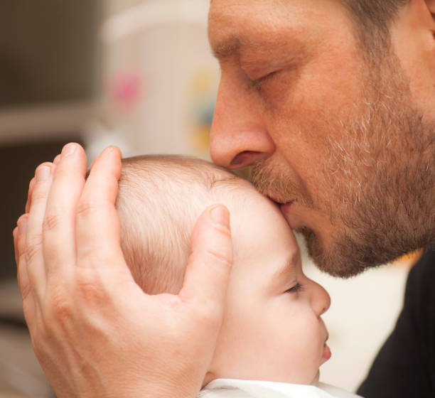 istock Father kissing his baby 927499078
