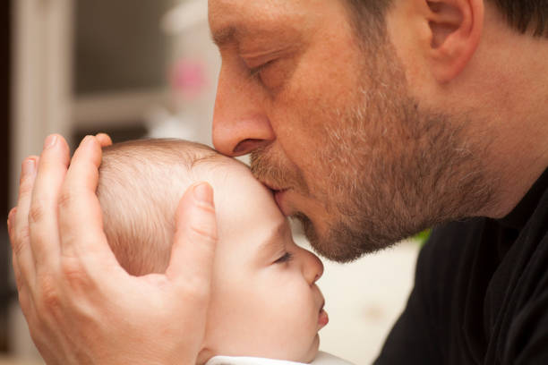 istock Father kissing his baby 927499080