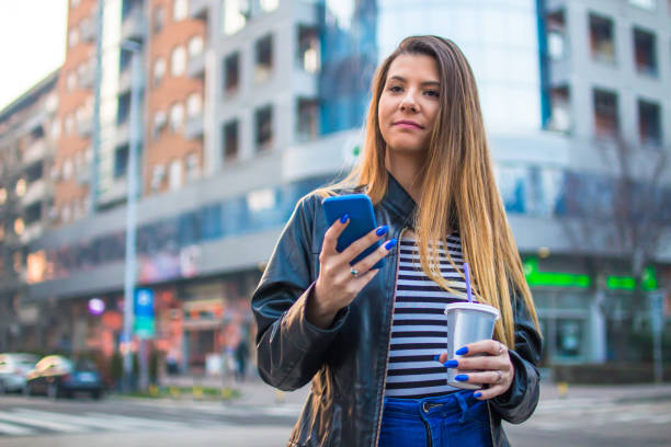 istock Girl on the street using mobile phone. 927499662