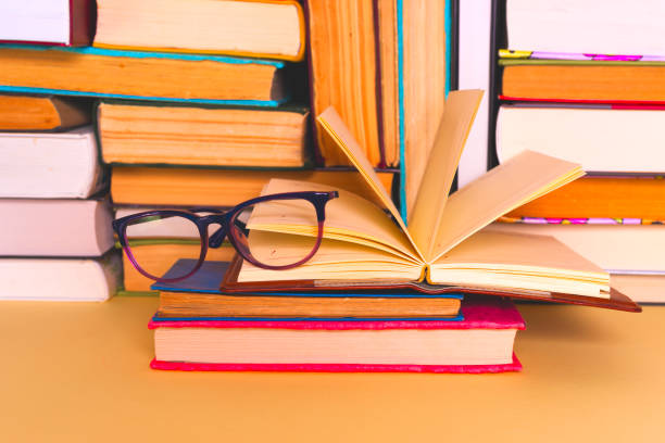 istock Open book, hardback books on bright colorful background. 927502582