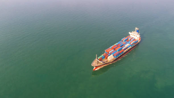 istock Container ship in export and import business and logistics. Shipping cargo to harbor by crane. Water transport International. Aerial view 927510676
