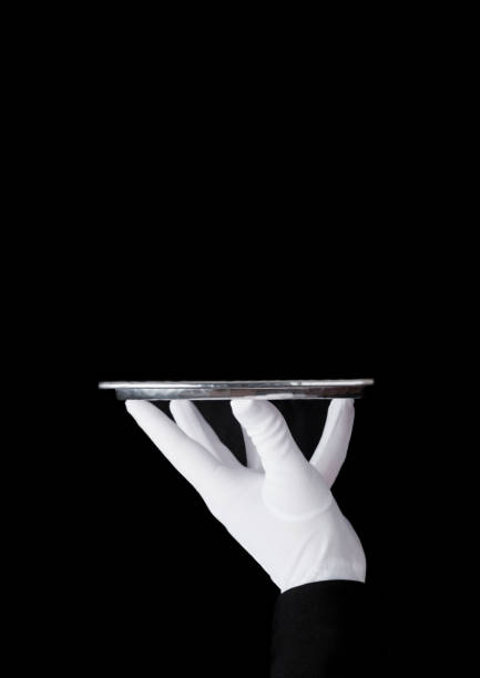 istock Servant white glove holds stainless steel tray 927510758
