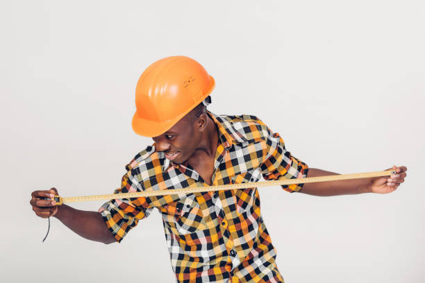 istock African-American builder uses measuring tape 927513522