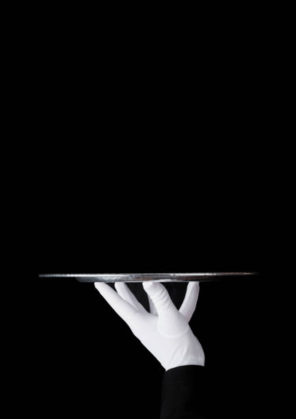 istock Servant white glove holds stainless steel tray 927517748