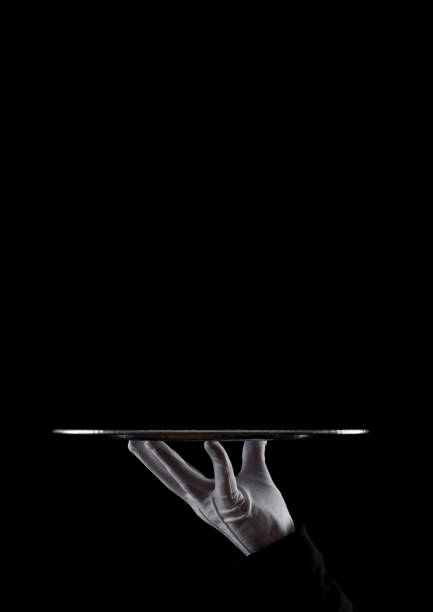 istock Servant white glove holds stainless steel tray 927518542