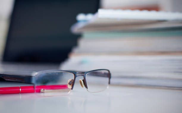 istock desktop with glasses in the foreground 927521694