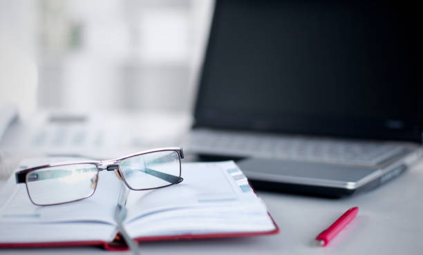 istock desktop with glasses in the foreground 927525804