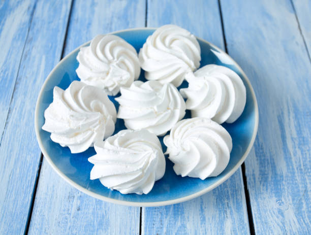 istock beautiful meringue on wooden surface 927530096