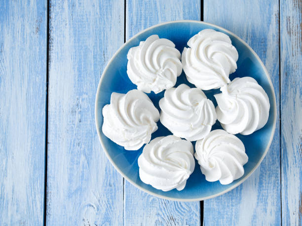 istock beautiful meringue on wooden surface 927530104