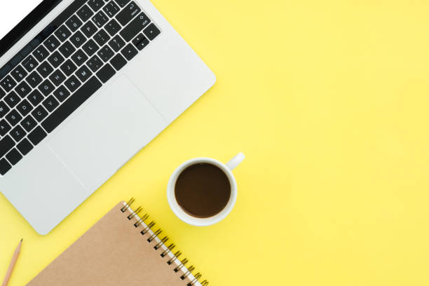 istock Minimal work space - Creative flat lay photo of workspace desk. Top view office desk with laptop, notebooks and coffee cup on pastel color background. Top view with copy space, flat lay photography. 927531252