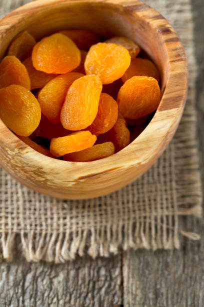 istock dried apricots on wooden table 927533790