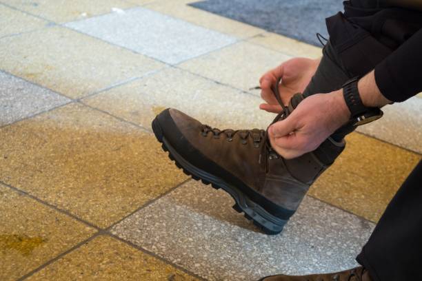 istock Man tying a sport shoe. 927534460