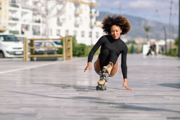 istock Black woman on roller skates falling to the ground. 927538762