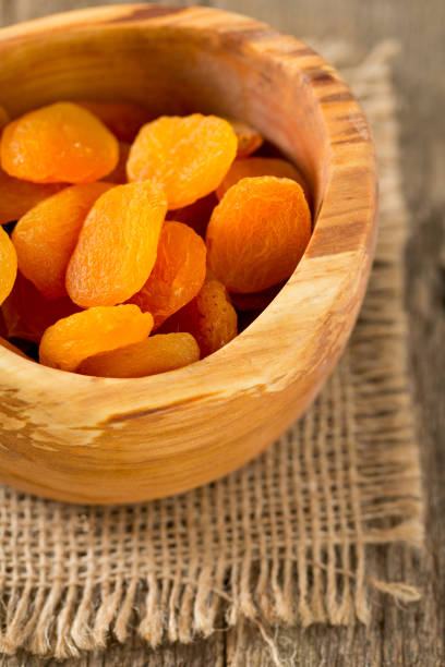 istock dried apricots on wooden table 927539770