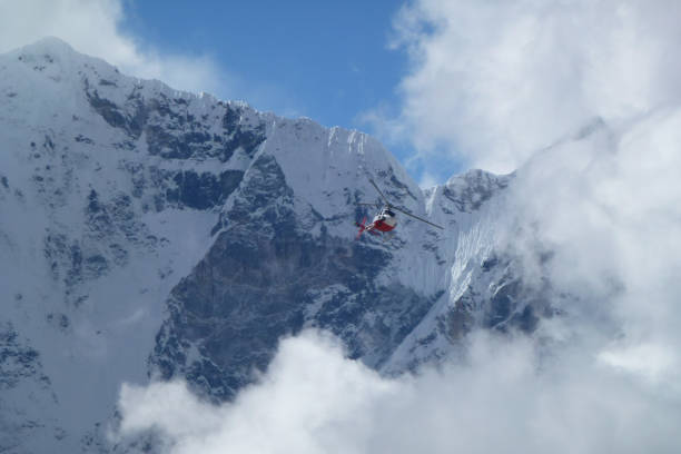 istock Rescue helicopter over big clouds, Gorak Shep, Everest Base Camp trek, Nepal 927548072