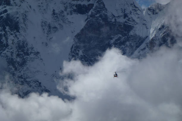 istock Rescue helicopter over big clouds, Gorak Shep, Everest Base Camp trek, Nepal 927548086