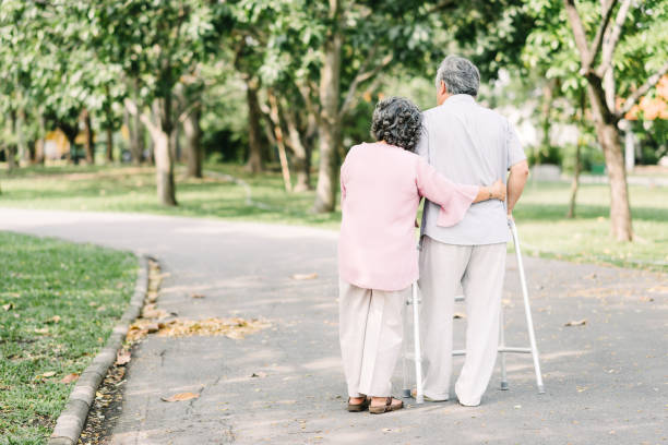 istock Senior couple talking a walk with walker 927548420