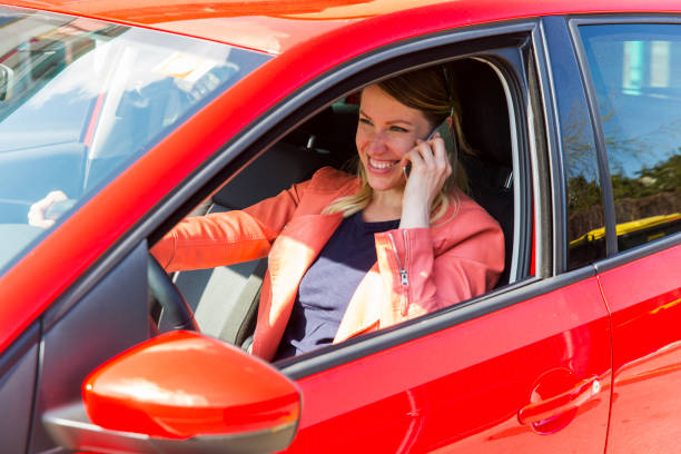 istock Young woman using phone in a car 927548496