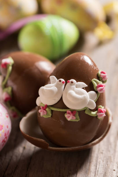 istock Decorated Chocolate easter egg on wooden table 927548750