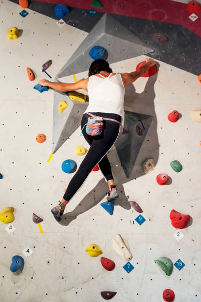 istock Woman practicing rock climbing on artificial wall indoors. Active lifestyle and bouldering concept. 927556190