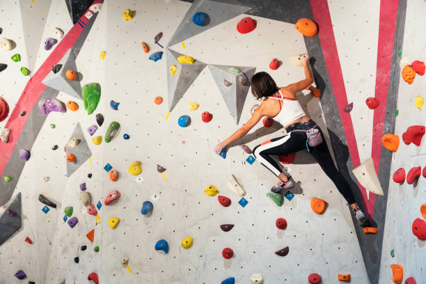 istock Woman practicing rock climbing on artificial wall indoors. Active lifestyle and bouldering concept. 927556196