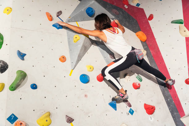 istock Woman practicing rock climbing on artificial wall indoors. Active lifestyle and bouldering concept. 927556228