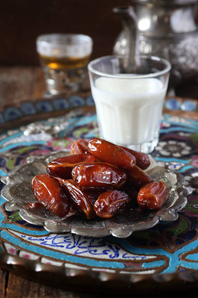 istock Ramadan food: ripe dates, green tea and fermented milk drink 927561494