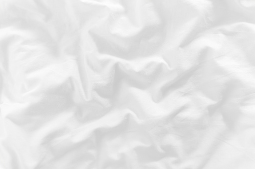 white crumpled bed sheet closeup top view