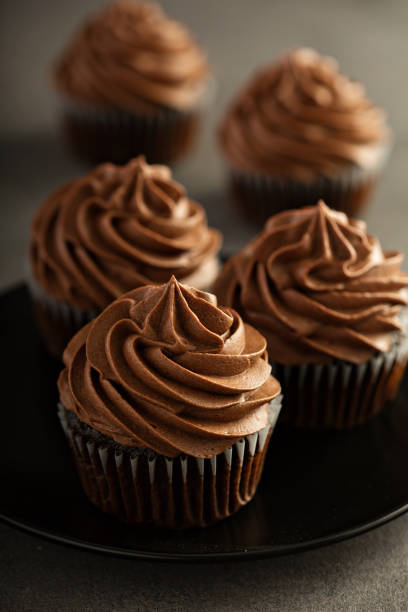 istock Dark chocolate cupcakes with ganache frosting 927568726