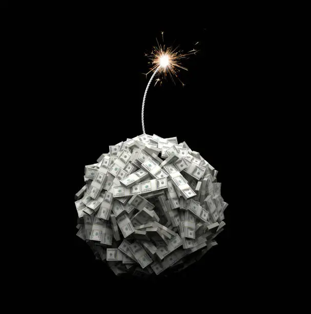 Bundles of US $100 notes form the shape of a globe and a fuse burns down towards the spherical mass of notes. This arrangement represents the current state of the world's economy as a ticking time bomb about to explode.