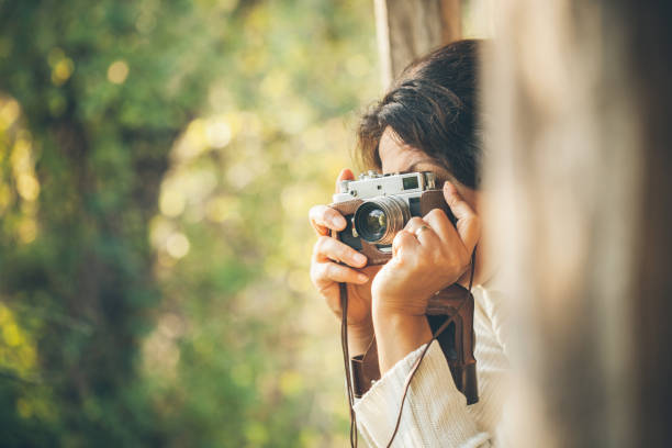 Woman and retro camera Woman and retro camera  in nature analog photos stock pictures, royalty-free photos & images
